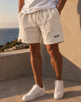 Hombre usando el short liviano manteca con remera blanca y zapatillas blancas